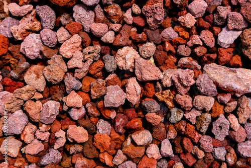 Obraz na plátně Volcanic lava rock texture, natural red and brown scoria stones creating an abst