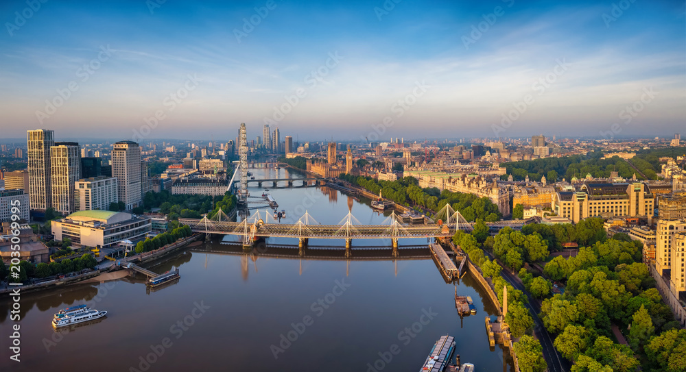 Fototapeta premium Panoramic aerial view of the skyline of London, England, with Southbank and Embankment, Westminster Palace back to Nine Elms during summer sunrise