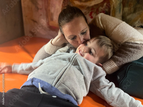 Mother kissing child's cheek showing love and bonding