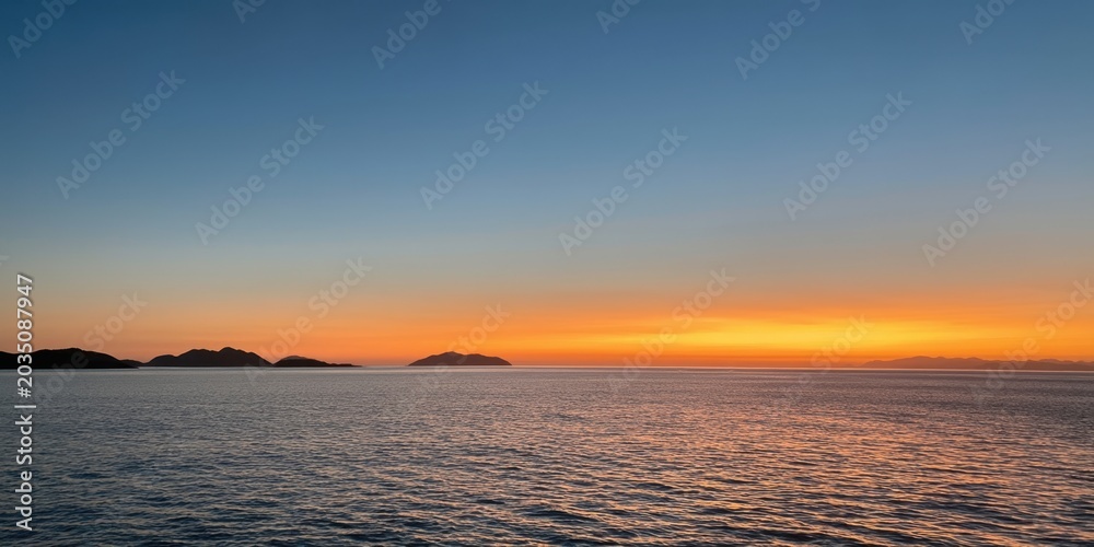 Obraz premium The Ocean at Sunset with Vibrant Horizon and Distant Silhouetted Islands