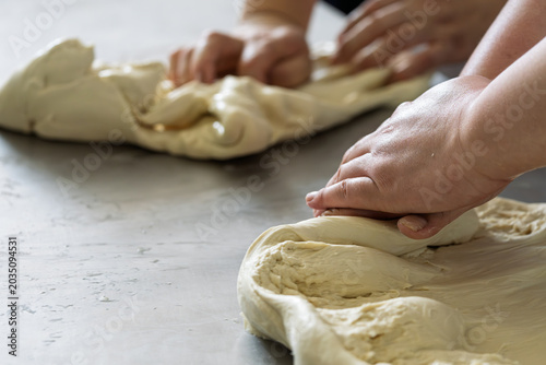 Cuadro en lienzo baker kneading raw dough on workbench with both hands