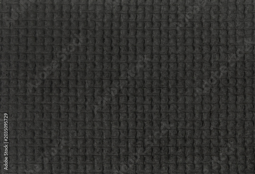 Black waffle texture fabric background closeup
