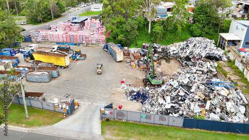 фотографія Aerial View of Industrial Scrapyard with Heavy Machinery and Metal Piles