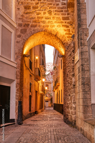 Charming narrow alley in Cadiz, Andalusia at Twilight