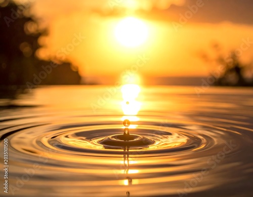 Golden Water Ripple Reflecting Sunset Light on Calm Surface at Dusk