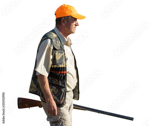 Hunter man in camouflage with a gun during the hunt in search of wild birds or game. Autumn hunting season.