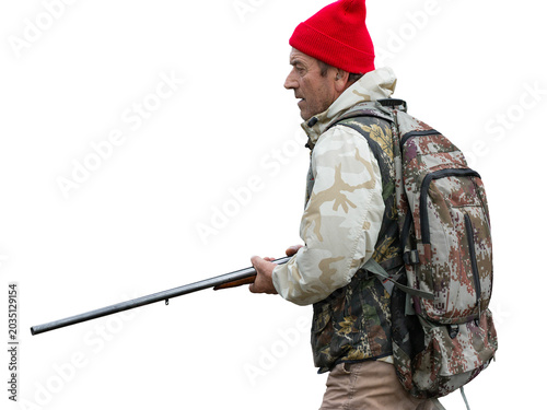 A hunter with a gun in camouflage clothing. A senior man with a gun, medium shot, searching for game.