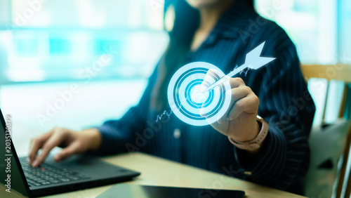 Fotografía Business target and success concept with glowing dartboard icon