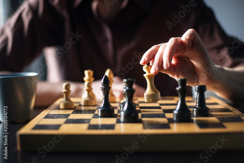 chess piece in female hands on a background