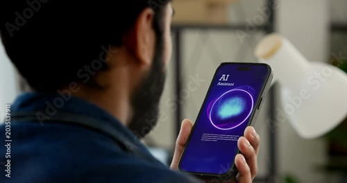 Businessman using a voice command features talking to a virtual AI assistant while working on a laptop at office. Speech recognition, Smart business entrepreneur technology and mobile automation.