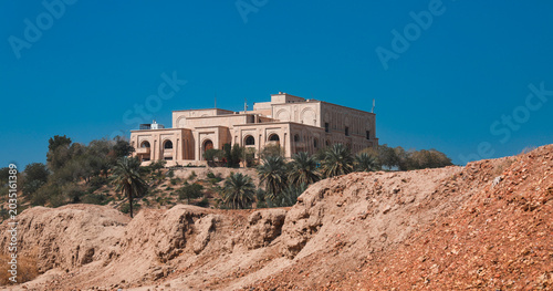 Views of Saddam Hussein Palace in Iraq with clear blue sky and surrounding landscape
