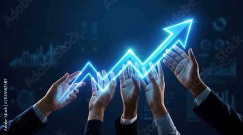 Multiple business hands supporting a glowing blue upward arrow against financial chart background, representing team-driven growth, corporate success and market prosperity.