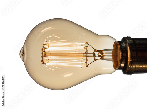 Fotografía Edison incandescent light bulb with visible filament and brass socket, isolated