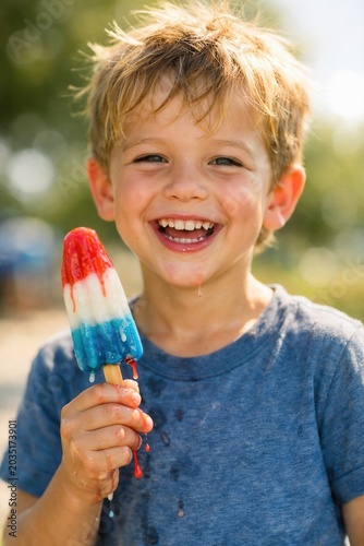 Happy child eating colorful ice cream popsicle outdoors summer fun joyful smiling kid portrait