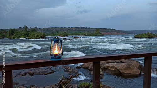 Cuadro en lienzo Oil lantern on railing overlooking white nile river rapids in butagaya, jinja, u