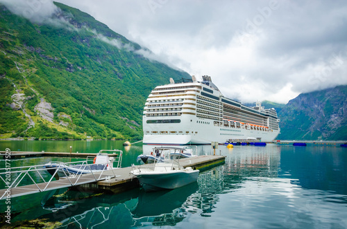 Cruise ship in port of town Geiranger, Geirangerfjord, one of the most beautiful fjords in Norway
