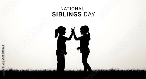 Silhouette of two sisters giving a high five on national siblings day