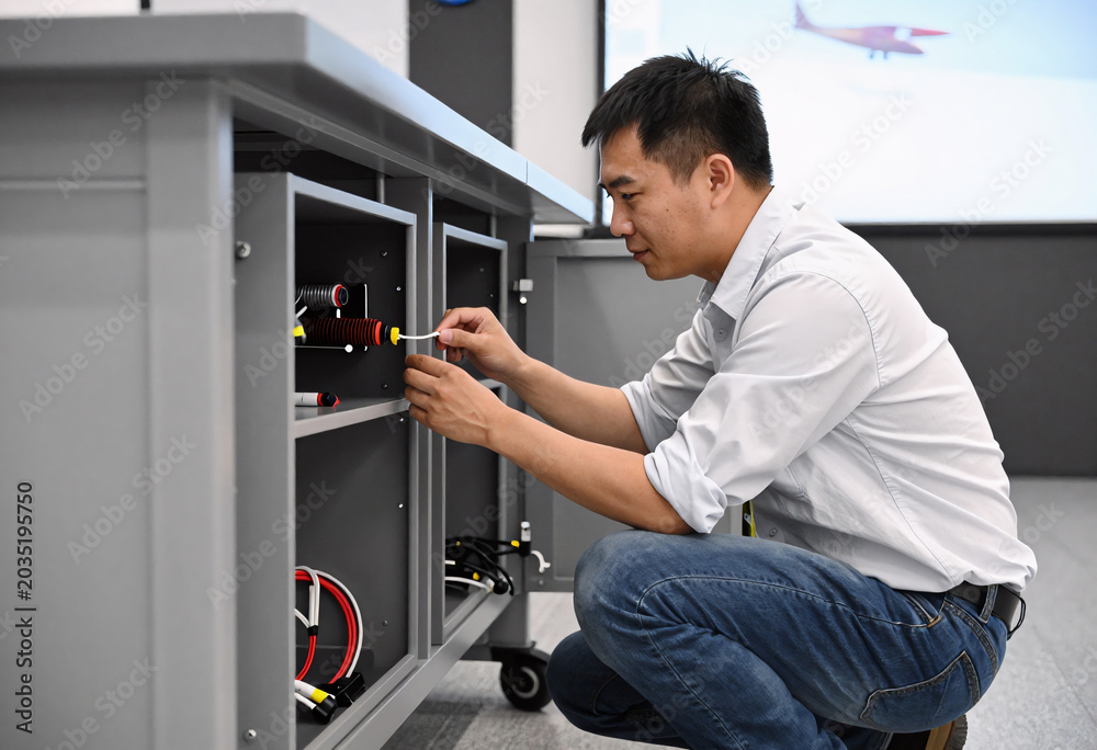 Fototapeta premium Aircraft Flight Simulator Technician at Work