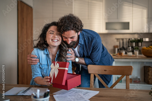 Konstfotografi Loving couple exchanging gift creating surprise and happiness