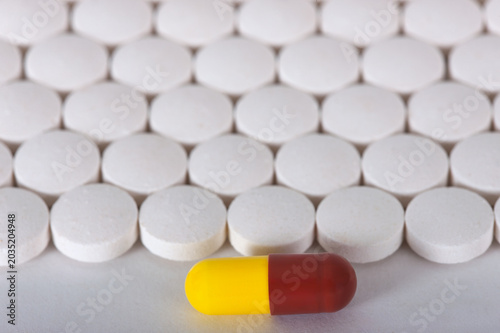 Photos substance abuse and overmedication, Yellow and brown capsule standing out agains