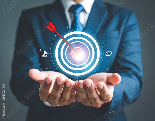 A man in a suit holding a glowing target in his hands