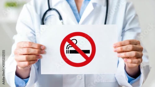 no smoking notice held by doctor in clinic, tobacco restriction sign for health care, smoke free policy, patient safety, prevention, respiratory wellness, medical warning, clean air message