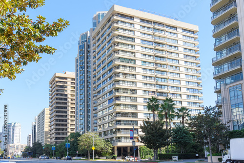 Luxury high rise modern apartment buildings along a large street on a clear autumn day