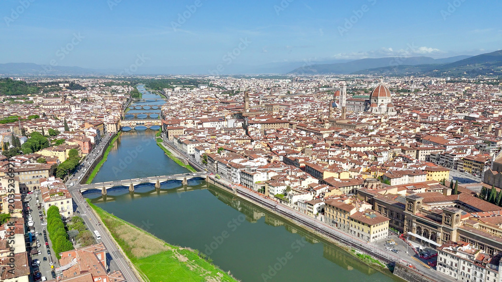 Fototapeta premium Drone aerial perspective Firenze Lungarni Arno River banks with Renaissance architecture colorful facades and Florence cityscape