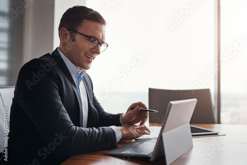 Tableau sur toile Laptop, paperwork and business man in office for research, stock trading and finance report