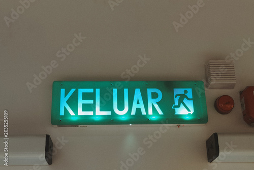 Illuminated Green Keluar Exit Sign for Public Building Safety and Emergency Direction with Copy Space Website Banner