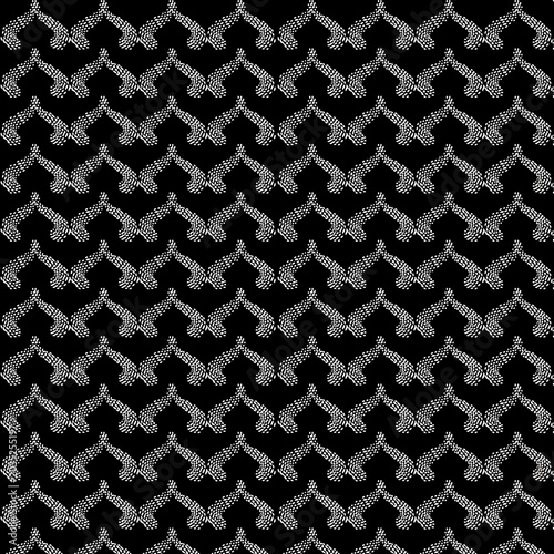 Black background with repeating pattern of white abstract geometric shapes