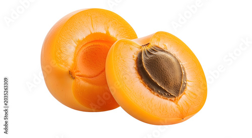 Fresh apricot cut in half revealing juicy flesh and brown seed on white background