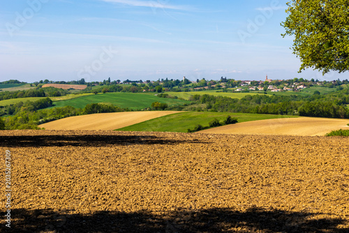 Village of Varennes (Tarn-et-Garonne) dominated by its Église Sainte-Germaine-de-Pibrac on a hilltop seen from the fields of Villemur-sur-Tarn