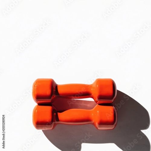 Minimalist Pair of Orange Dumbbells on White Background with Copy Space, Professional Fitness Equipment for Strength Training and Health Marketing Hero Header