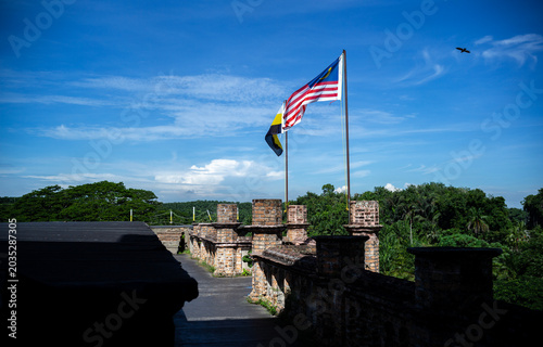 Malaysian and Perak State Flags Waving on Castle Rooftop