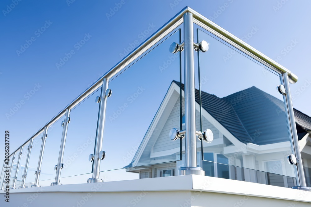 Fototapeta premium Modern Glass Balustrade And Stainless Steel Railing On A Building Terrace