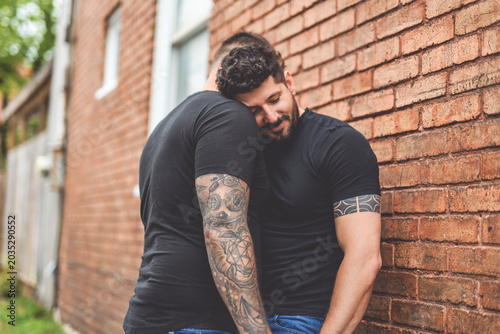 A Portrait of a happy gay couple outdoors in urban background
