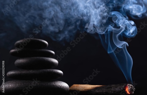 Zen Wellness Spa Background with Stacked Stones and Smoldering Palo Santo Wood for Meditation Website Banner Hero Header with Copy Space