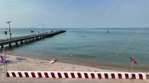 Tropical Sandy Beach with Long Pier and Calm Turquoise Sea in Vietnam