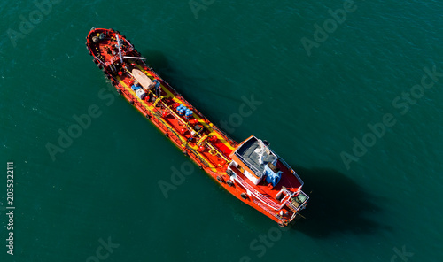 Foto High angle drone view of a red oil product tanker underway on calm seas