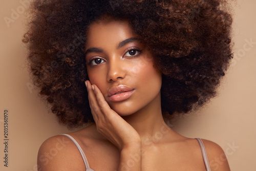 Beauty portrait of African American girl with afro hair. Beautiful black woman. Cosmetics, makeup and fashion