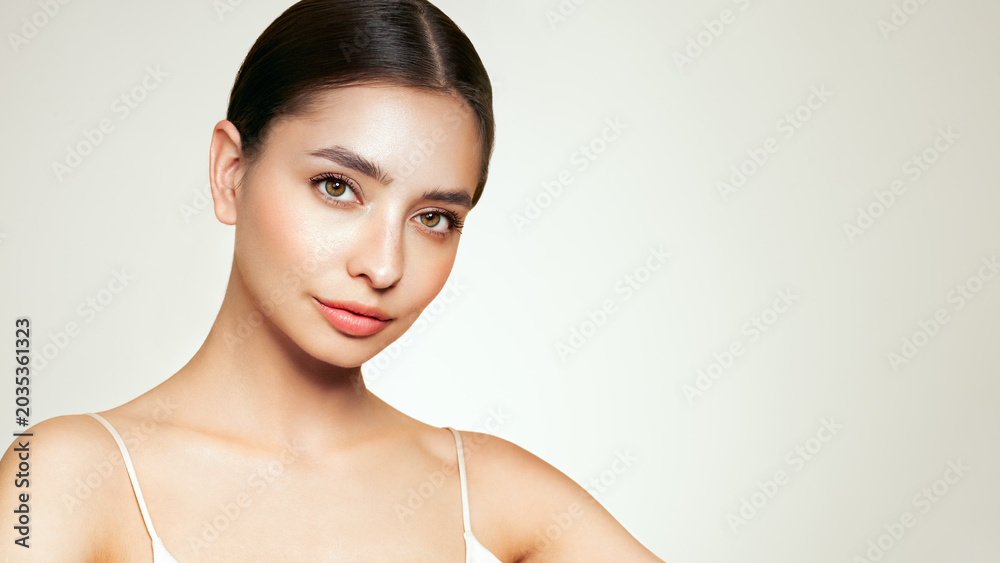 Fototapeta premium Portrait beautiful young woman with clean fresh skin. Model with healthy skin, close up portrait. Cosmetology, beauty and spa