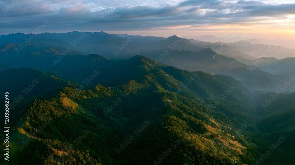 Naklejka premium A breathtaking aerial view of majestic mountain ranges bathed in the warm golden light of the golden hour