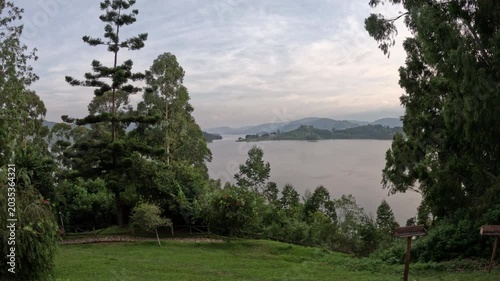 Cinematic morning view over Lake Bunyonyi with mist rising above calm water and scenic island landscape travel video