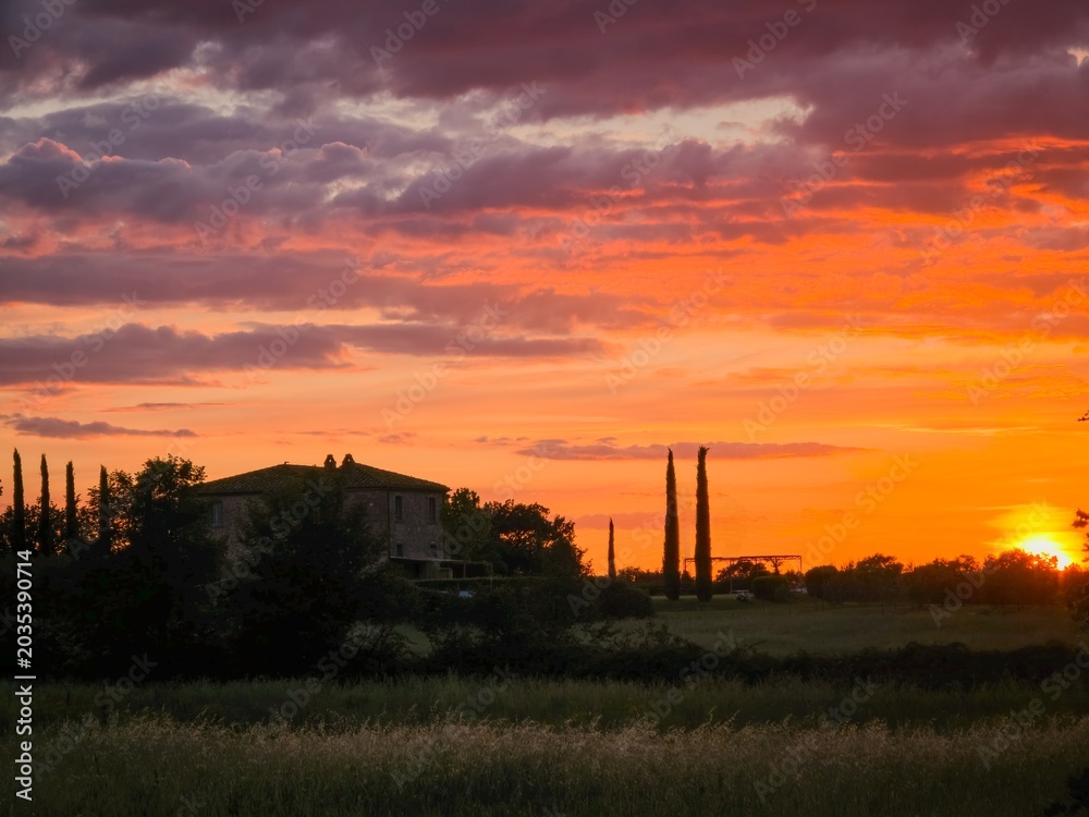 Naklejka premium Dramatic sunset over Tuscan countryside in Italy