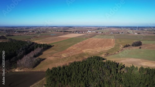 Forward drone flight above forest and agricultural fields