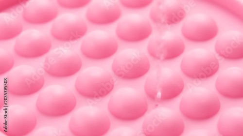 Close up of pink textured surface with raised bumps.
