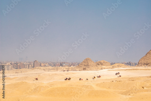 The Giza Pyramids in Cairo, Egypt, panoramic view. General view of the pyramids from the Giza plateau. Three pyramids, known as the Queen's Pyramids, are on the front.
