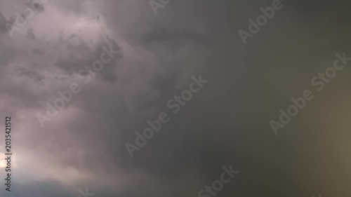 Cinematic cloudscape timelapse of a heavy rainfall and thunderstorm approaching with dark grey clouds.