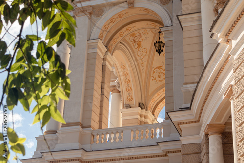Ornate elegant building facade with arches and decor in sunny city downtown